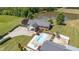 Captivating aerial view of the home, showcasing the pool, expansive driveway and meticulously landscaped grounds at 1199 Cesar Ct, Graham, NC 27253