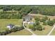 Expansive aerial view showcases the property's pond, mature trees, and surrounding landscape at 1199 Cesar Ct, Graham, NC 27253