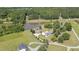 Stunning aerial view displays the property's pond, green landscape, and spacious layout at 1199 Cesar Ct, Graham, NC 27253