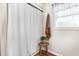 Bright bathroom featuring a white shower curtain, wooden stool, and a decorative plant for a spa-like feel at 1199 Cesar Ct, Graham, NC 27253