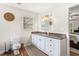 Bathroom with white cabinets, wood-look floors, granite countertops, and modern fixtures at 1199 Cesar Ct, Graham, NC 27253
