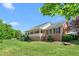 Brick home with covered front porch, mature trees, green grass and well-maintained landscaping at 1199 Cesar Ct, Graham, NC 27253