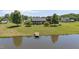 Lovely exterior view of the house showing a pond with dock, a canoe and expansive lawn at 1199 Cesar Ct, Graham, NC 27253