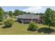 Appealing exterior shot of the house with brick, white trim and lawn, complemented by lush landscaping at 1199 Cesar Ct, Graham, NC 27253