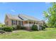 Beautiful one-story brick home with a covered front porch and manicured landscaping at 1199 Cesar Ct, Graham, NC 27253