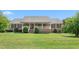 Charming single-story brick home with a welcoming front porch and lush green lawn at 1199 Cesar Ct, Graham, NC 27253