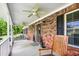 Welcoming front porch with a ceiling fan, brick exterior, and a cozy rocking chair at 1199 Cesar Ct, Graham, NC 27253