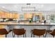 Spacious kitchen featuring light wood cabinetry, granite countertops and a stylish pendant light fixture at 1199 Cesar Ct, Graham, NC 27253