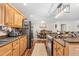 Well-lit kitchen showcases granite counters, wood cabinets, and stainless steel appliances at 1199 Cesar Ct, Graham, NC 27253