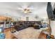 Open-concept living room with a large sectional sofa, hardwood floors, and a ceiling fan at 1199 Cesar Ct, Graham, NC 27253