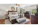 Spacious main bedroom with a wooden bed frame, sitting area, and hardwood floors throughout at 1199 Cesar Ct, Graham, NC 27253