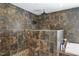 Bathroom with a dual-head shower featuring mosaic tile surround and pebble stone flooring at 1199 Cesar Ct, Graham, NC 27253
