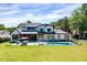 Expansive backyard featuring a sleek pool, patio furniture, and a lush green lawn, perfect for entertaining at 1209 Briar Patch Ln, Raleigh, NC 27615