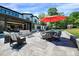 Beautiful backyard featuring a dining set, seating, green grass, and an orange umbrella at 1209 Briar Patch Ln, Raleigh, NC 27615