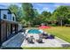 Spacious backyard with an inviting pool, patio dining set, lounge chairs, and a sprawling green lawn at 1209 Briar Patch Ln, Raleigh, NC 27615
