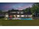 Stunning backyard with a modern pool, lounge area, and manicured lawn, ideal for outdoor living at 1209 Briar Patch Ln, Raleigh, NC 27615