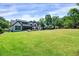 Vast backyard with a luxurious pool, outdoor seating area, and a wide expanse of green grass for recreation at 1209 Briar Patch Ln, Raleigh, NC 27615