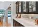 A modern bar area with black cabinets, marble counters, and a mirrored tile backsplash at 1209 Briar Patch Ln, Raleigh, NC 27615