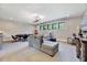 Spacious basement featuring a lounge area, poker table, and natural light at 1209 Briar Patch Ln, Raleigh, NC 27615