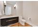 Elegant powder room with modern fixtures, marble countertop, and stylish vanity at 1209 Briar Patch Ln, Raleigh, NC 27615
