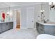 Dual vanity in a light and bright bathroom featuring marble flooring and modern lighting at 1209 Briar Patch Ln, Raleigh, NC 27615