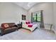 Bedroom featuring neutral carpet, a ceiling fan, natural light, and comfortable seating at 1209 Briar Patch Ln, Raleigh, NC 27615