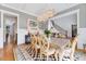 Elegant dining room adjacent to the living room features stylish lighting and neutral wall paint at 1209 Briar Patch Ln, Raleigh, NC 27615