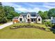 Exterior view of a landscaped two-story home with a manicured lawn at 1209 Briar Patch Ln, Raleigh, NC 27615