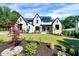 Beautifully landscaped front lawn and exterior view of a two-story home with a stone and brick facade at 1209 Briar Patch Ln, Raleigh, NC 27615