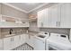 Well-equipped laundry room with modern washer, dryer, sink and ample storage at 1209 Briar Patch Ln, Raleigh, NC 27615
