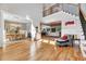 Spacious, open-concept living area with hardwood floors, elegant decor, and a grand staircase at 1209 Briar Patch Ln, Raleigh, NC 27615