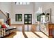 Bright, high-ceiling living room with hardwood floors and an abundance of natural light streaming through the windows at 1209 Briar Patch Ln, Raleigh, NC 27615