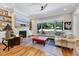 Comfortable living room with fireplace, built-in shelving, and large windows at 1209 Briar Patch Ln, Raleigh, NC 27615