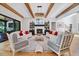Living room with a fireplace, built-in bookshelves, wood beams, and comfortable seating at 1209 Briar Patch Ln, Raleigh, NC 27615