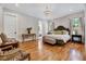Spacious main bedroom with a chandelier, hardwood floors, and natural light at 1209 Briar Patch Ln, Raleigh, NC 27615