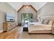 Spacious main bedroom with vaulted ceilings, wood beams, and a seating area by the windows at 1209 Briar Patch Ln, Raleigh, NC 27615