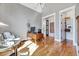 Bright home office featuring a large window, hardwood floors, and neutral wall paint at 1209 Briar Patch Ln, Raleigh, NC 27615