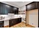 Pantry features dark cabinets, subway tile backsplash, and open shelving at 1209 Briar Patch Ln, Raleigh, NC 27615