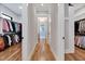 Spacious walk-in closet with hardwood floors and custom shelving for clothing and accessories at 1209 Briar Patch Ln, Raleigh, NC 27615