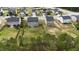 Aerial view showcasing houses within a residential area surrounded by lush green trees at 126 Thimbleweed Ln, Lillington, NC 27546