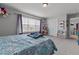 Bright bedroom features a comfortable bed, large window, soft carpet, and ample storage at 126 Thimbleweed Ln, Lillington, NC 27546