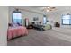 Large bedroom with multiple beds, soft carpet, windows, and ceiling fan at 126 Thimbleweed Ln, Lillington, NC 27546
