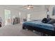 Large bedroom with king bed, soft carpet, ceiling fan, and attached full bathroom at 126 Thimbleweed Ln, Lillington, NC 27546