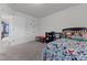 Bedroom featuring a patterned bedspread, gray carpeting, and access to the closet and room at 126 Thimbleweed Ln, Lillington, NC 27546