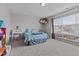 Spacious bedroom features a charming decor, soft carpet, and a large window with natural light at 126 Thimbleweed Ln, Lillington, NC 27546