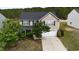 Traditional two-story home featuring a two-car garage, well-maintained lawn, and mature trees at 126 Thimbleweed Ln, Lillington, NC 27546