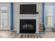 Modern fireplace in a cozy living room with neutral walls and curtains at 126 Thimbleweed Ln, Lillington, NC 27546