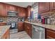 Kitchen featuring stainless steel appliances and stylish tile backsplash at 126 Thimbleweed Ln, Lillington, NC 27546