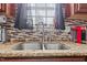 Close-up of a kitchen sink with granite countertops and a tiled backsplash at 126 Thimbleweed Ln, Lillington, NC 27546