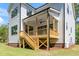 Back porch featuring a ceiling fan and wood stairs and railings at 1301 Doylin Dr, Cary, NC 27511
